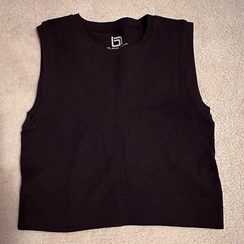 Blanc Noir perforated solid mid-drift top.